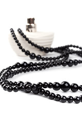 Image showing black necklace and parfume