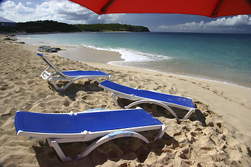 Image showing Red parasol with loung chair
