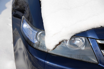 Image showing Snow covering a headlight