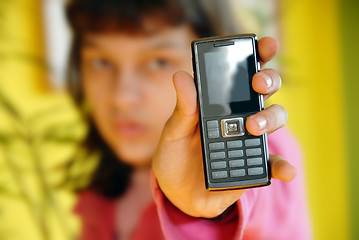 Image showing Teen girl showing her mobile phone