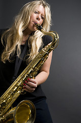 Image showing sexy blond female saxophone player musician 