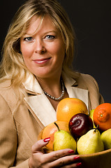 Image showing pretty older woman in suit fruit bowl