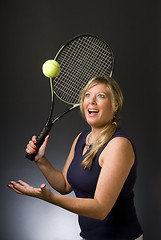 Image showing woman tennis player happy serving ball