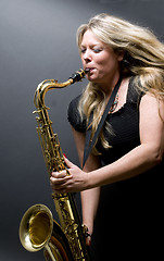 Image showing sexy blond female saxophone player musician
