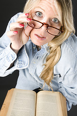 Image showing pretty attractive blond woman close up reading glasses book