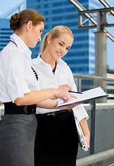 Image showing two happy businesswomen with paper chart