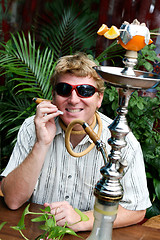 Image showing Man smoking a hookah.