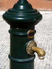 Image showing Historic green water pump