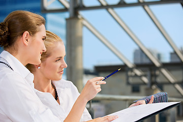 Image showing two happy businesswomen with paper chart