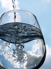 Image showing Glass of pouring water with reflection