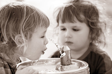 Image showing Two boys by the drinking fountain