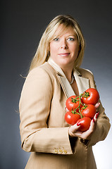 Image showing attractive blond woman with bunch tomatoes fresh  for healthy li