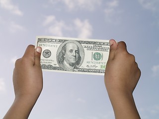 Image showing holding 100 dollar