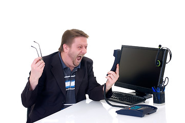 Image showing Angry businessman on desk 