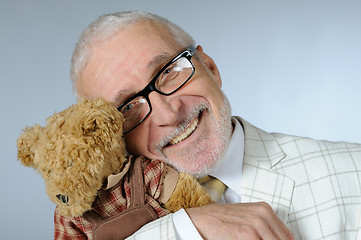 Image showing Happy senior businessman with teddy bear