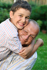 Image showing Grandfather and kid outdoors