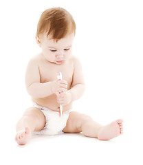 Image showing baby boy in diaper with toothbrush