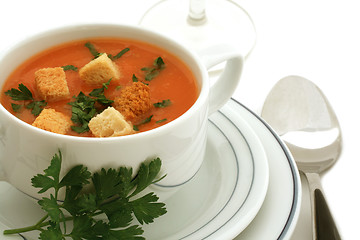 Image showing Tomato soup with croutons in ceramic bowl on white