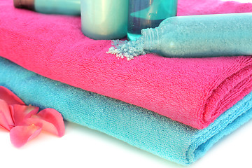 Image showing Pink and blue towels with shampoo, solt, cream, body lotion, bat