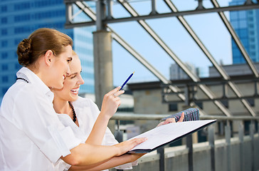 Image showing two happy businesswomen with paper chart