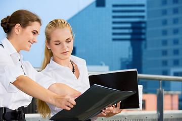 Image showing two happy businesswomen with documents