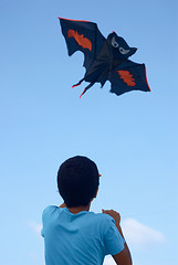 Image showing Playing with a paper kite in the sky