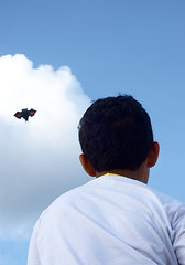 Image showing Playing with a paper kite in the sky