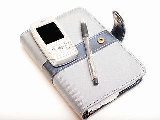 Image showing Office objects - Pen diary and a cell phone