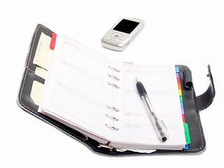 Image showing Office objects - Pen diary and a cell phone