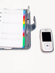 Image showing Office objects - Pen diary and a cell phone