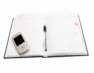 Image showing Business Objects - Diary open with cellphone on  white