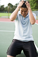 Image showing Disappointed tennis player