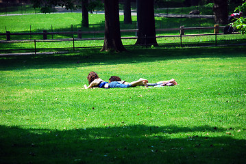 Image showing Friends relaxing on green grass