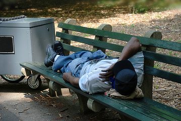 Image showing Worker sleeping on park bench