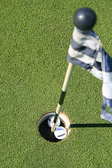 Image showing Golf Course Flag And Two Golf Balls