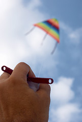 Image showing Playing with a paper kite in the sky