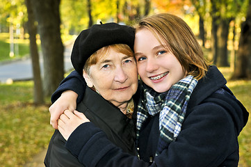 Image showing Granddaughter hugging grandmother