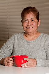 Image showing Woman having a cup of coffee at home