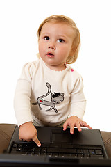 Image showing Adorable baby with laptop