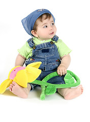 Image showing Baby girl holding flower