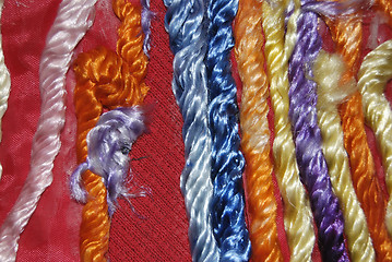 Image showing Red Canvas Decorated With Colored Fibres