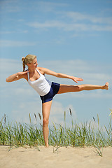 Image showing Beautiful female workout on the beach