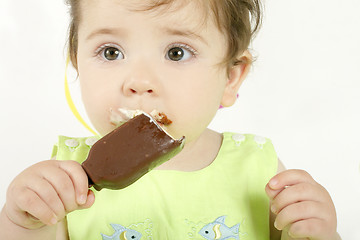 Image showing Baby girl eating an ice cream mini