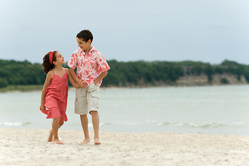 Image showing Kids walking on the beach