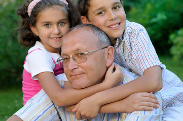 Image showing Grandfather and kids outdoors