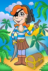 Image showing Pirate woman with pistol and treasure chest