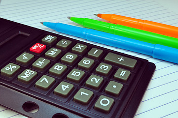 Image showing Calculator, pens and notebook