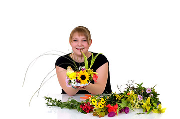 Image showing Young girl arranging flowers 