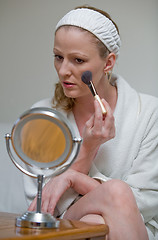 Image showing Putting on makeup