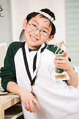 Image showing Winning boy with his medal and trophy